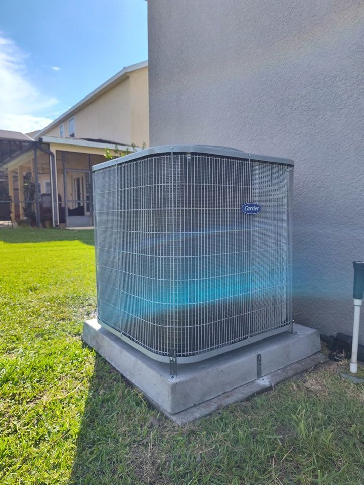 a large air conditioner is sitting on the side of a house .