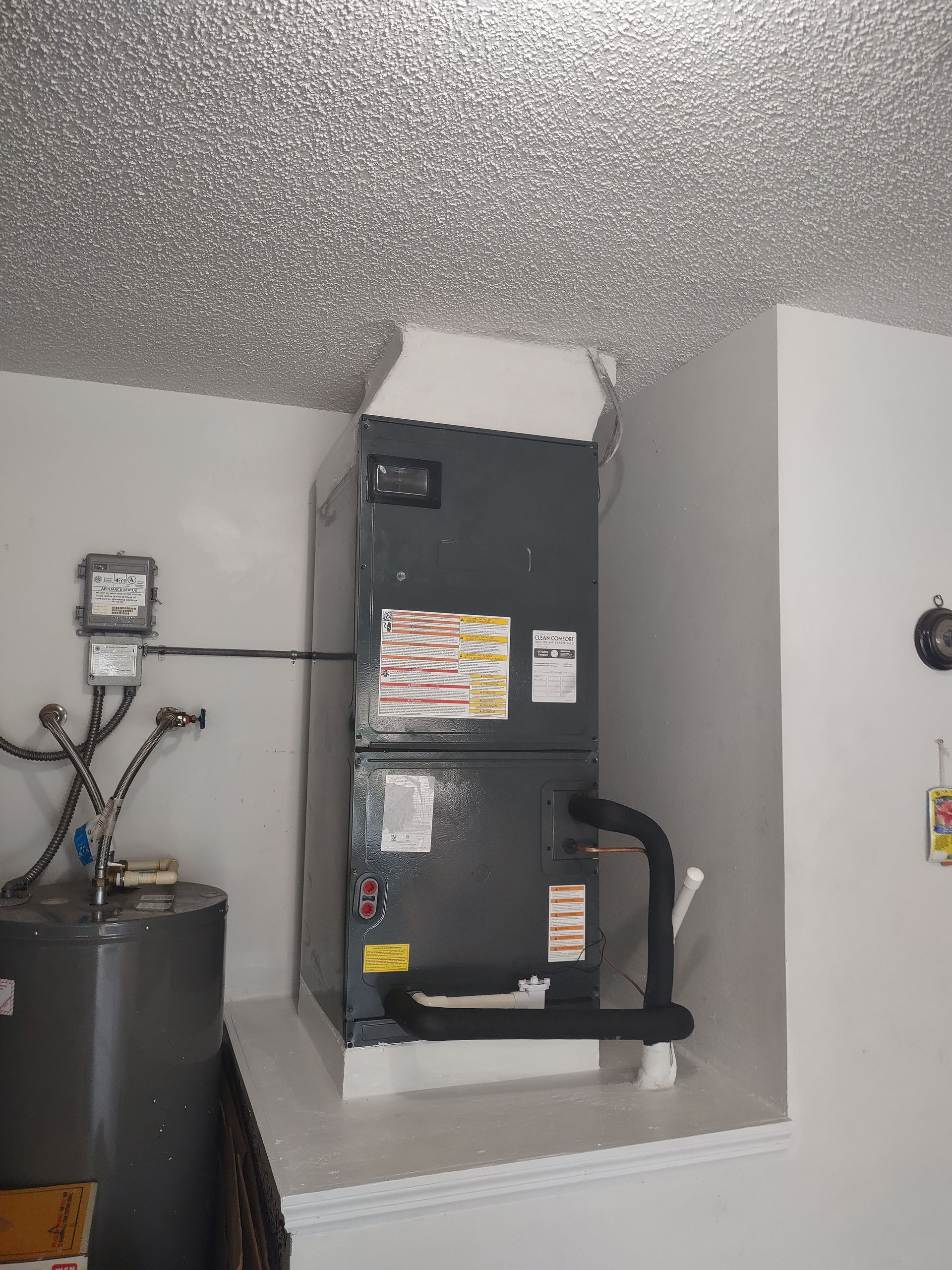 a room with a water heater and an air conditioner .