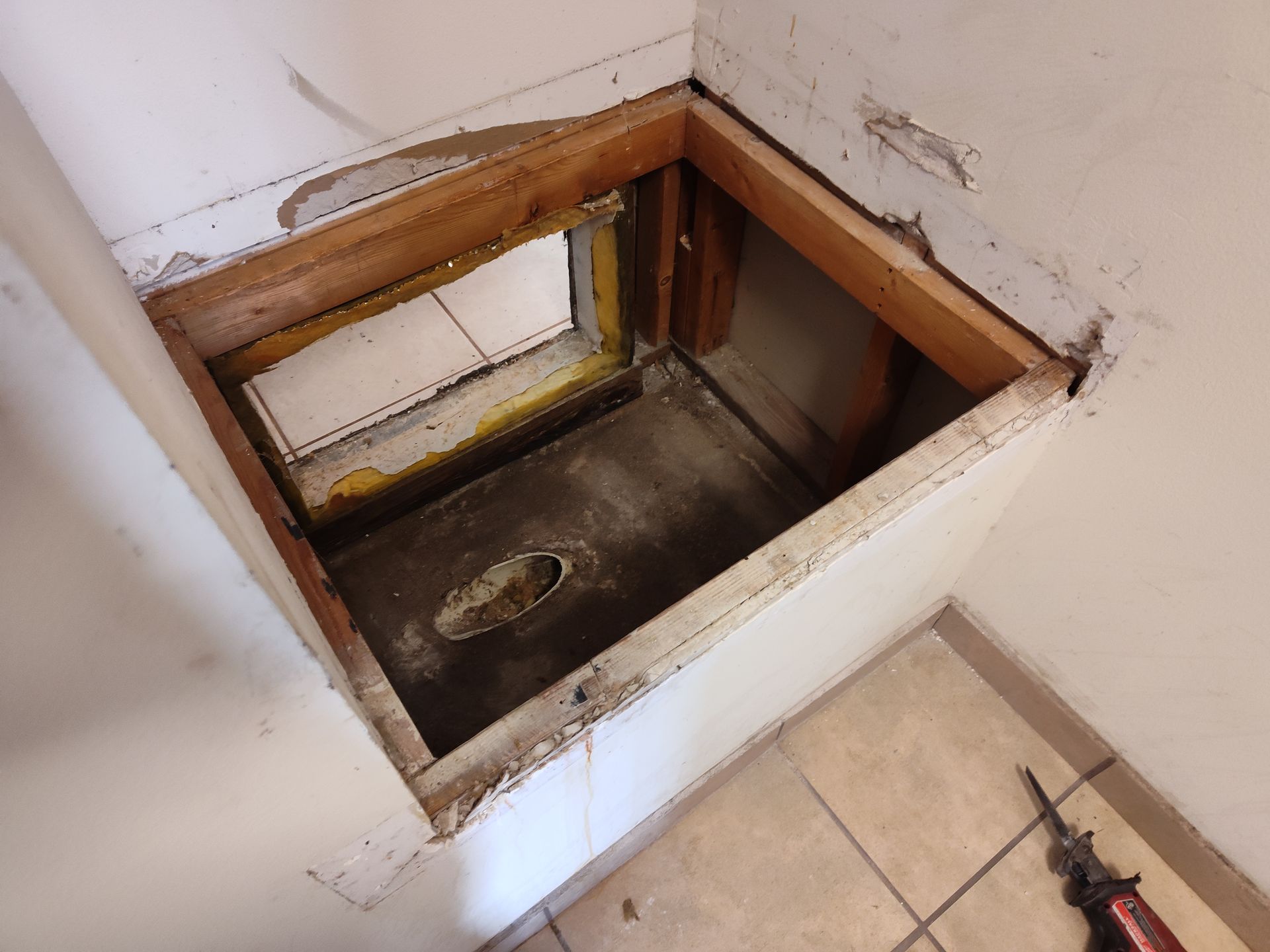 a hole in a wall with a window in it