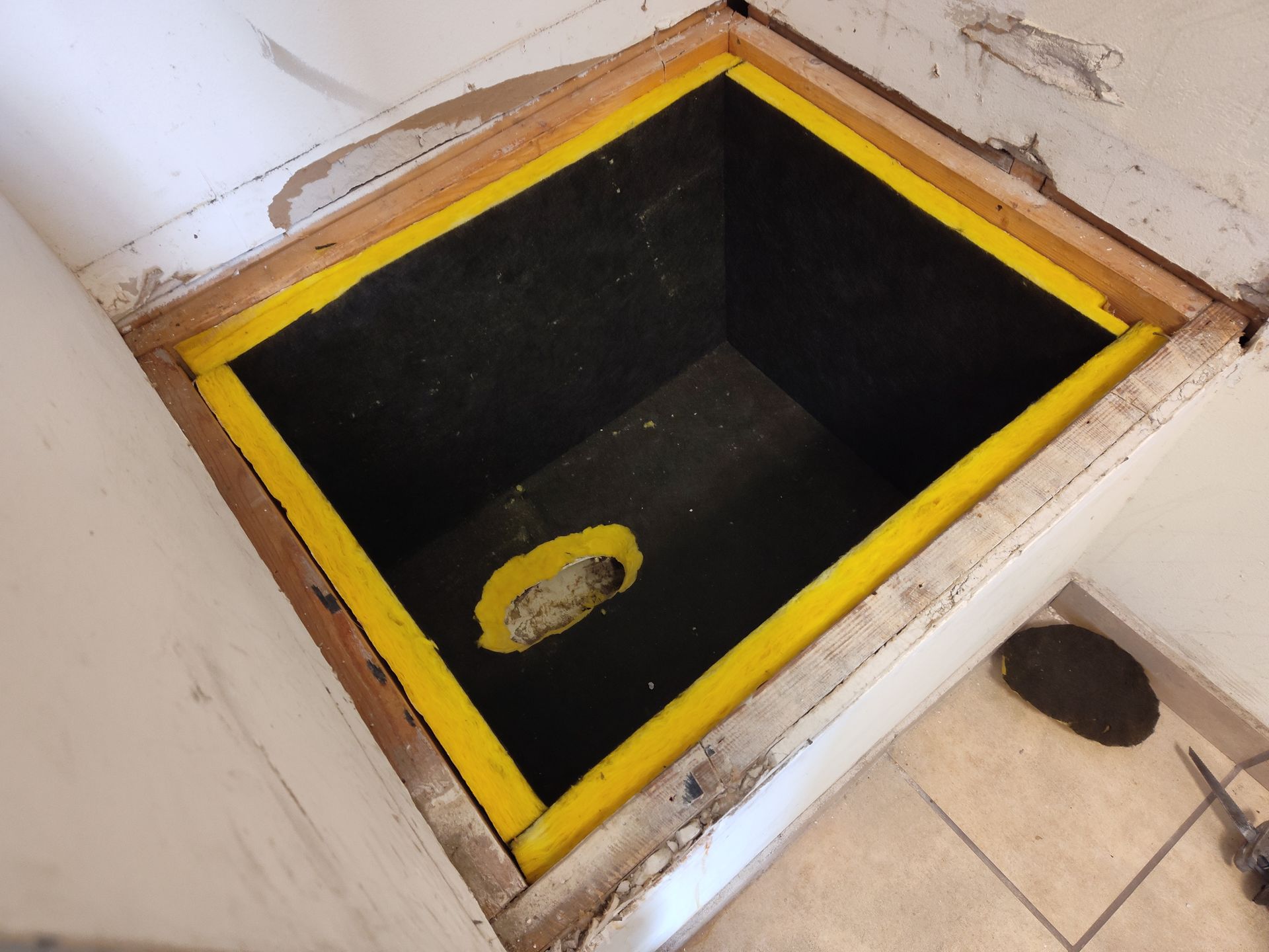 a black box with a yellow border and a hole in the middle