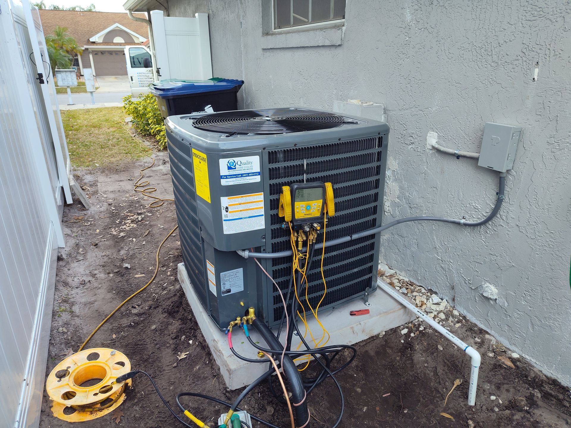 an air conditioner is being installed on the side of a house .