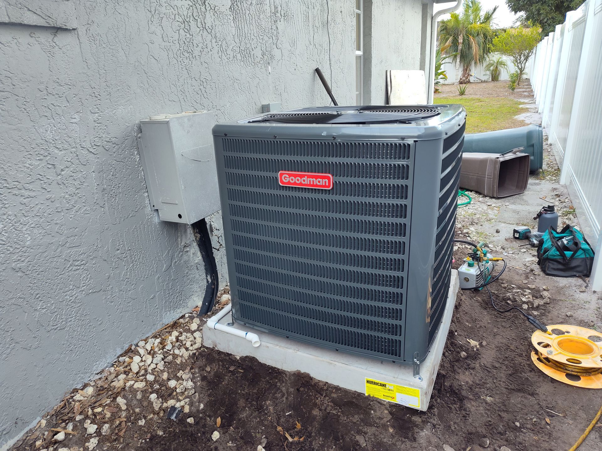 a large air conditioner is sitting on the side of a building .