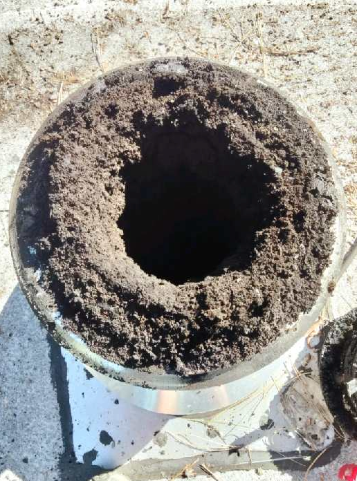 Chimney cleaning company photo of clogged chimney needing professional chimney sweeping service.