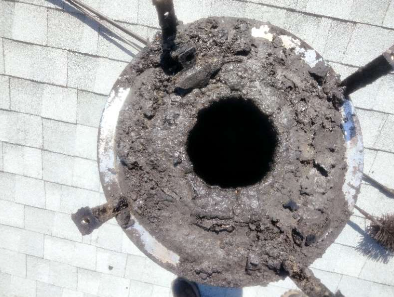 Chimney cleaning company photo showing a blocked flue before chimney sweeping and maintenance.