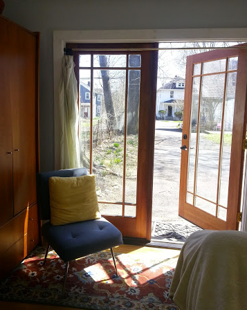 A Room With a Chair and a Door That is Open