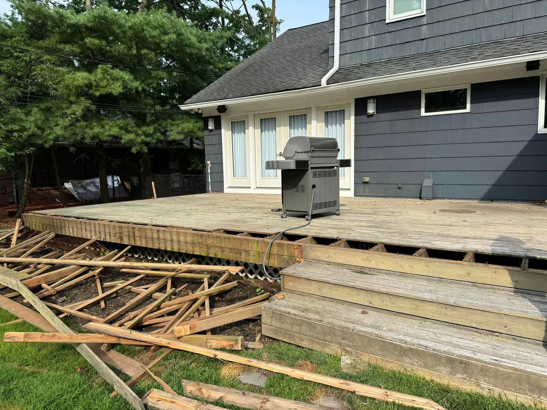 Bathroom with white herringbone tile, glass shower door, black hardware, and recessed shelves.