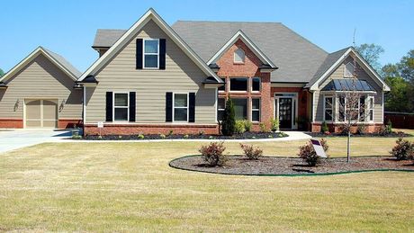 A large house with a lot of windows and shutters