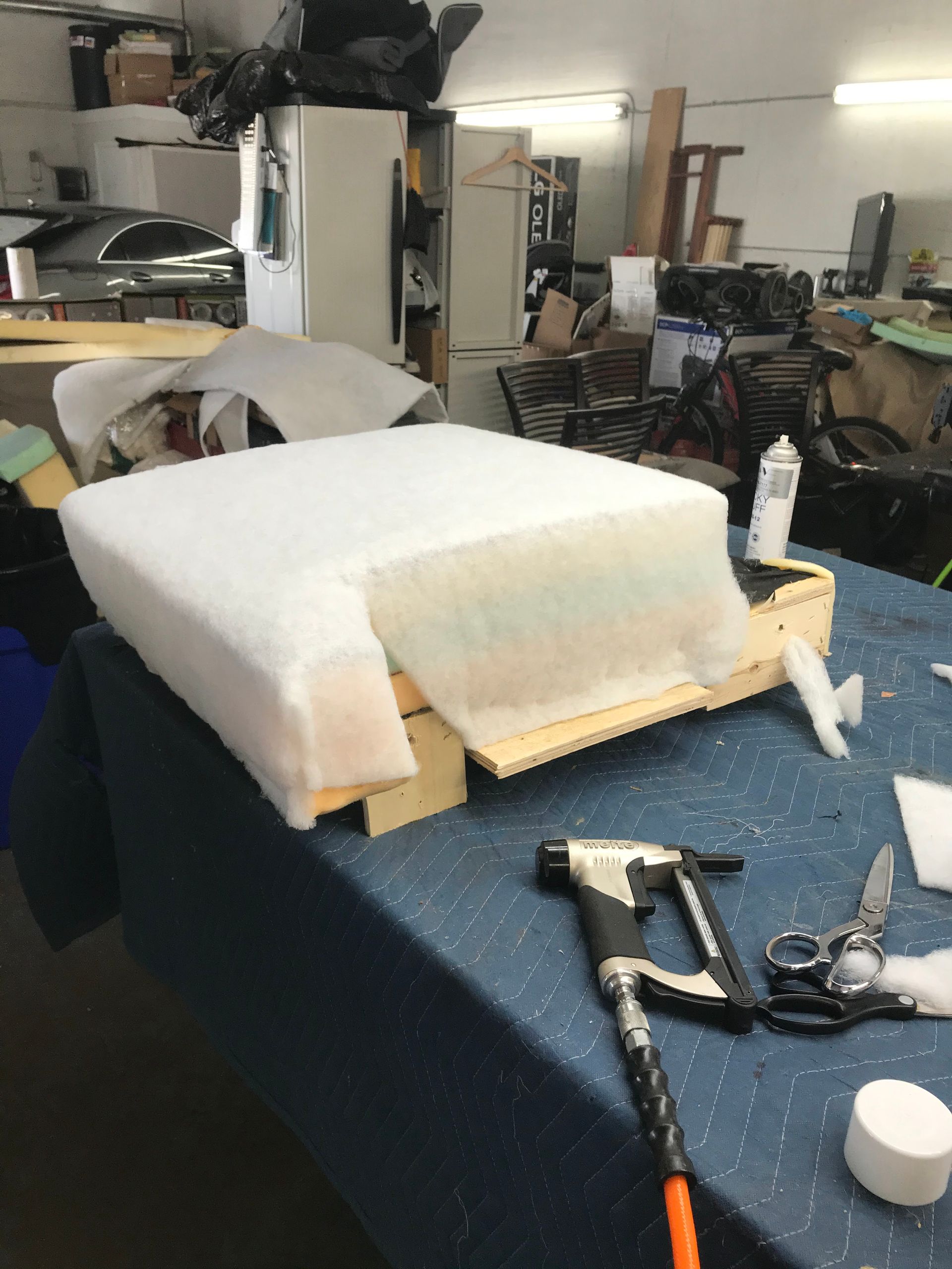 A piece of foam is sitting on a table in a workshop.
