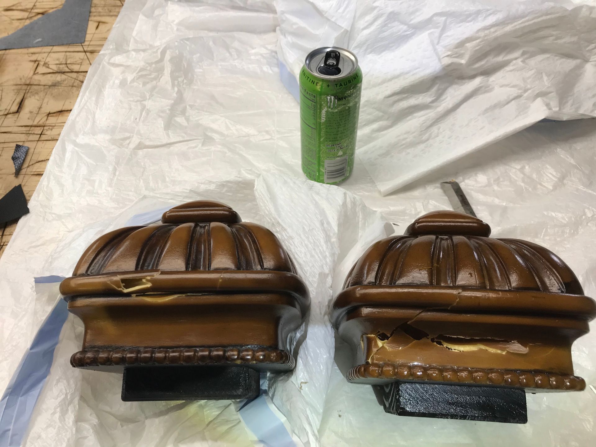 Two wooden boxes are sitting on a table next to a can of soda.
