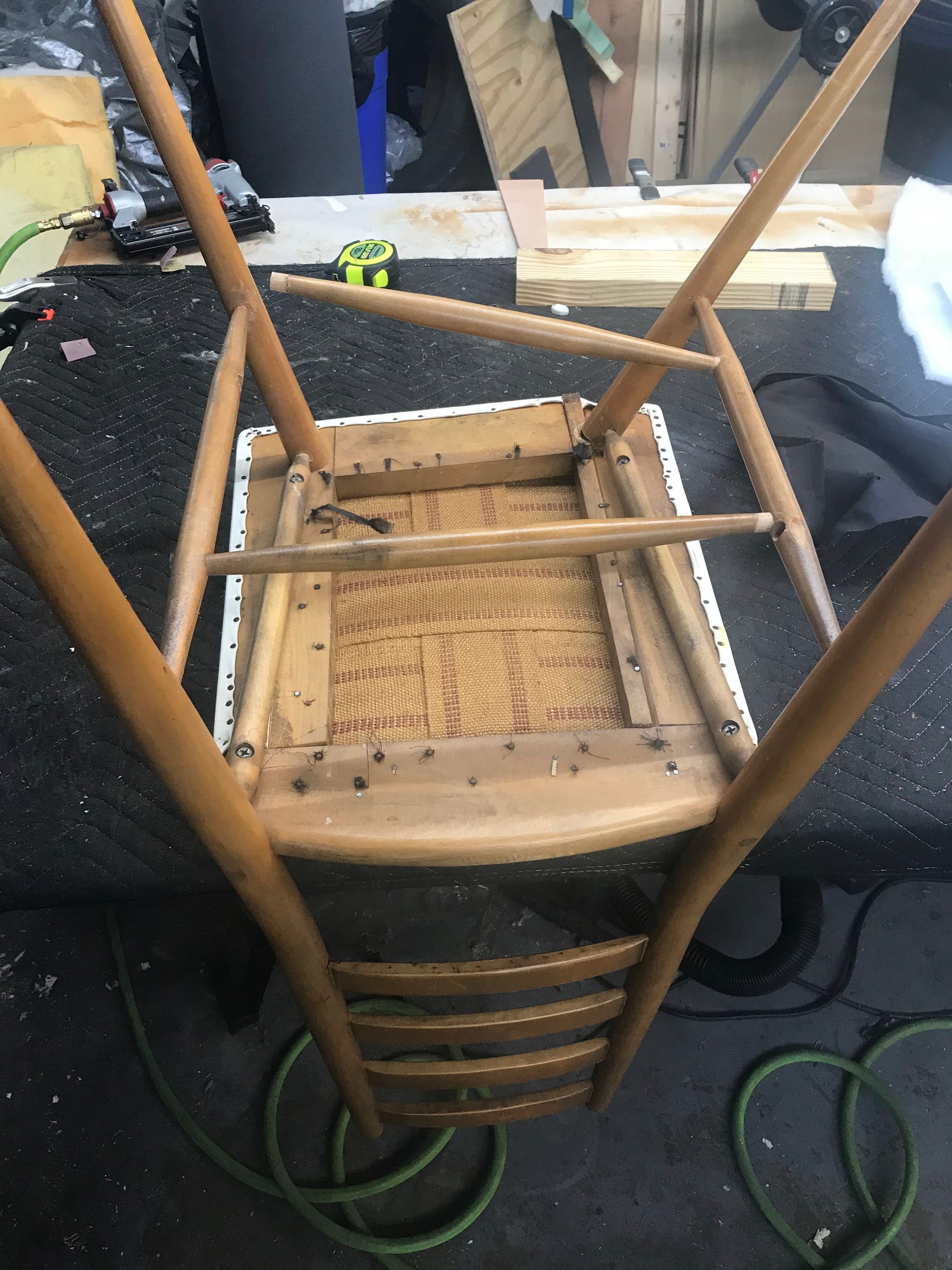 A wooden chair is sitting on top of a table.