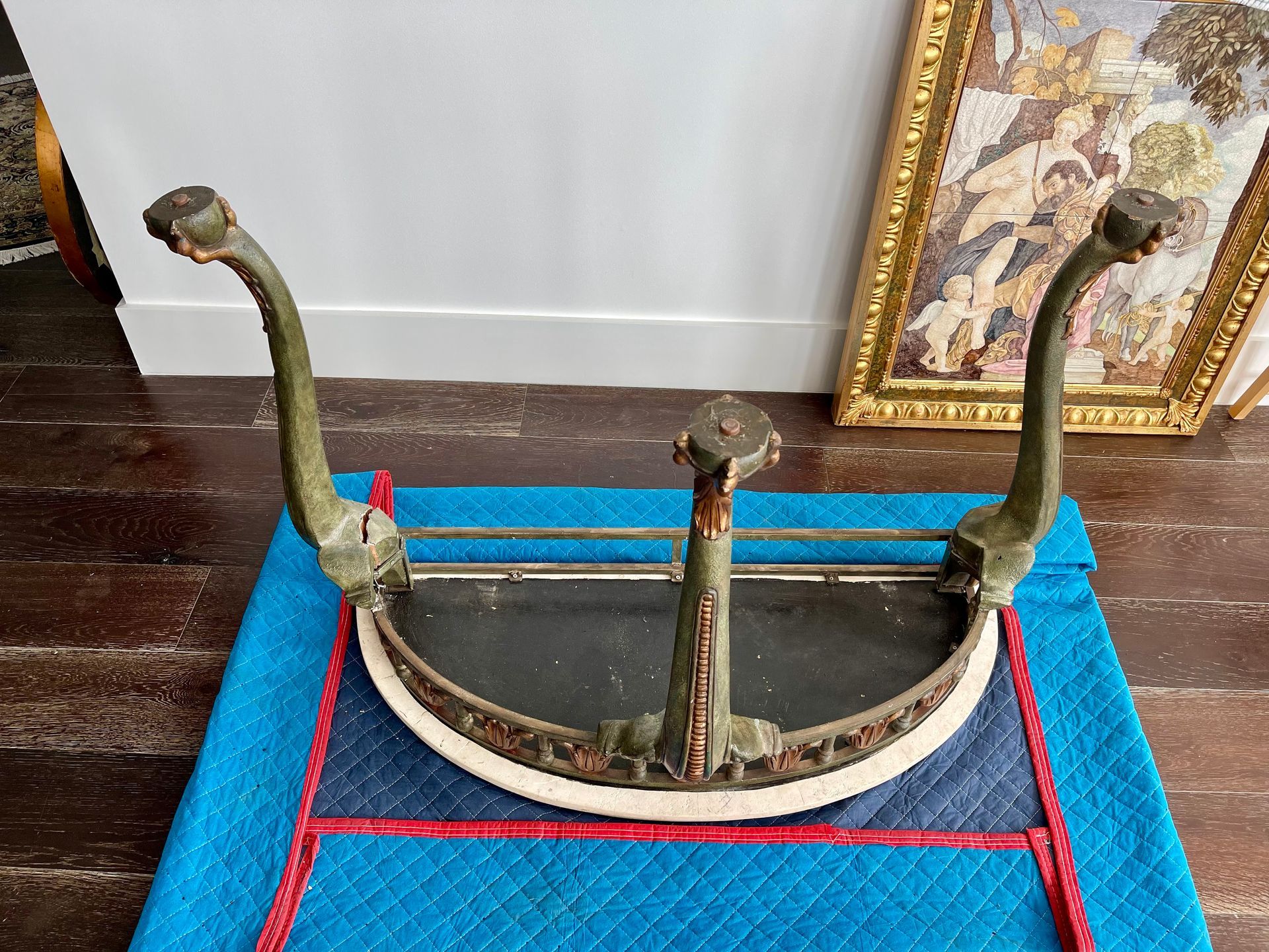 A chair is sitting on top of a blue blanket on a wooden floor.