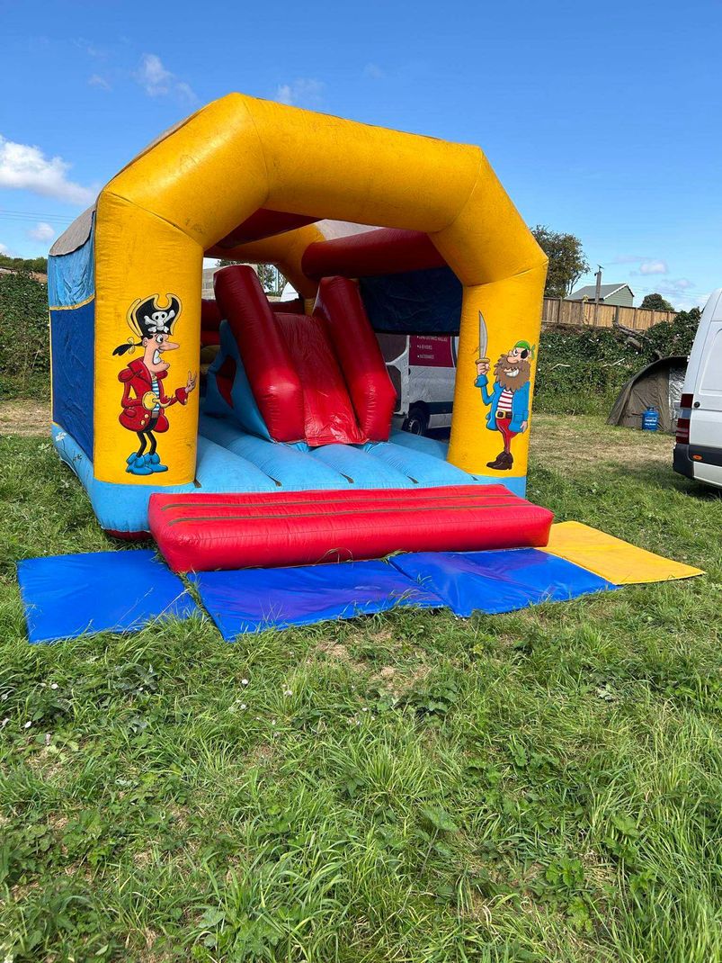 Happy family enjoying bouncy castle hire from Domino Entertainment