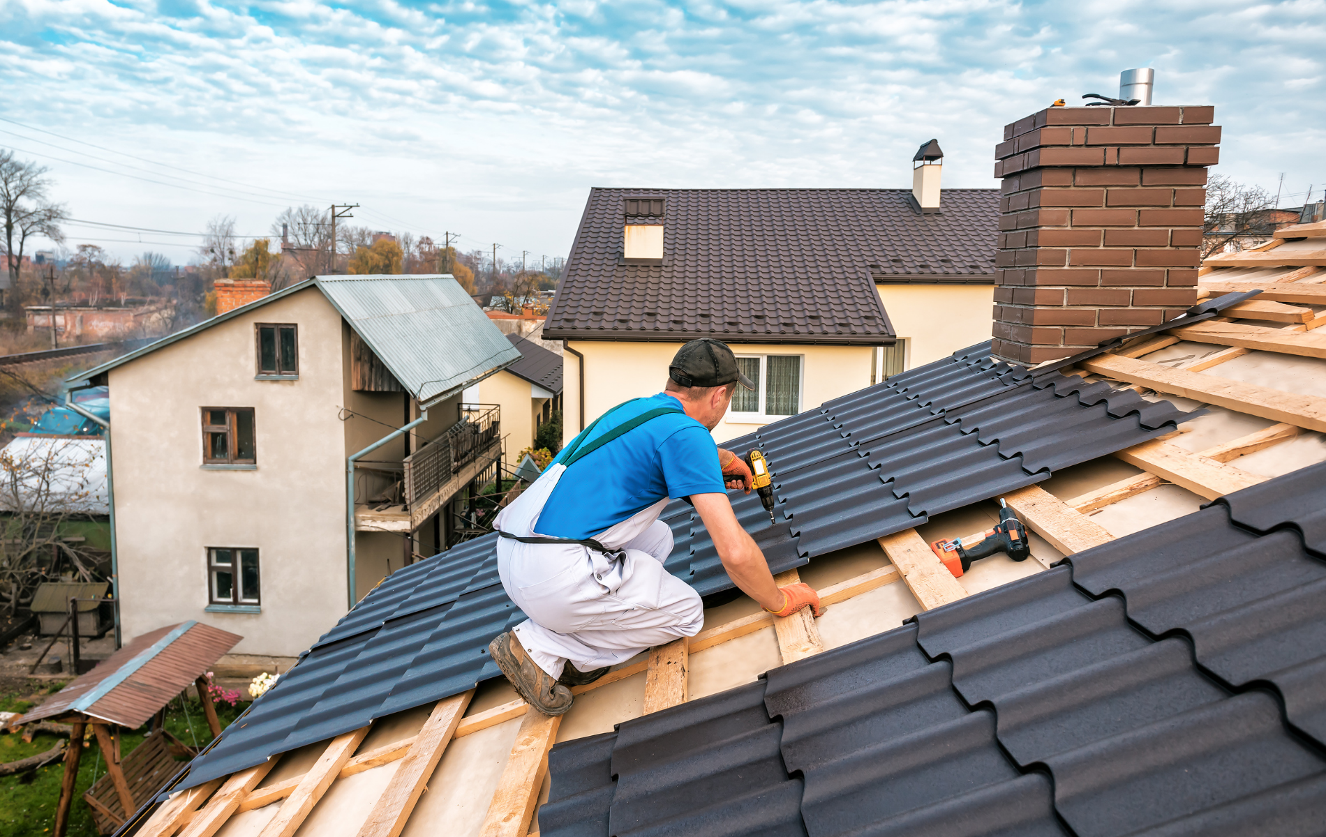 A man is working on the roof of a house.