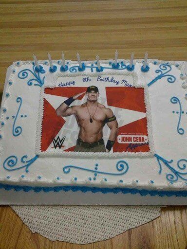 Cake decorated with John Cena image, blue accents, and 