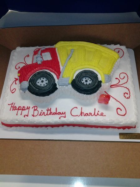 Cake decorated as a red and yellow dump truck with 