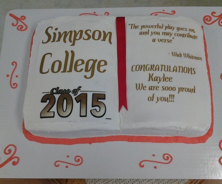 Cake decorated like a book for Simpson College graduate Kaylee. Gold text, red ribbon, and a quote.