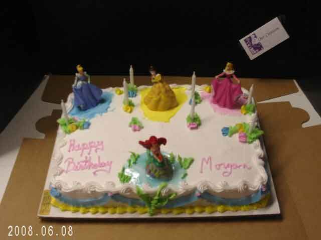 Birthday cake decorated with Disney princesses.