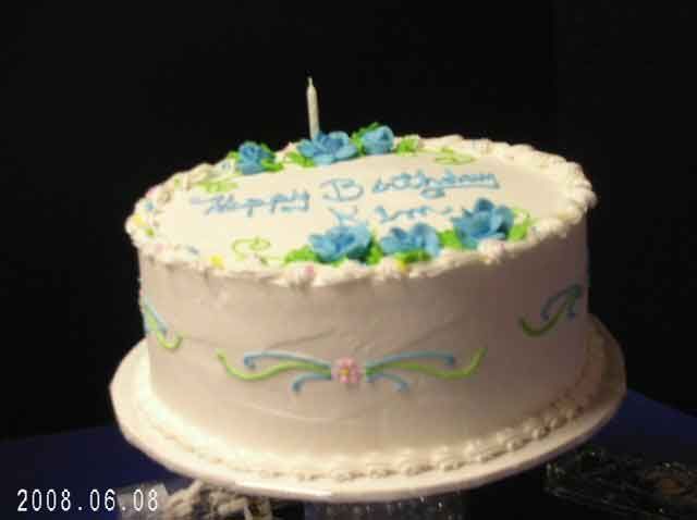 Birthday cake with blue frosting and flowers, 