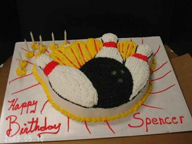 Birthday cake shaped like a bowling scene with pins, ball, and 