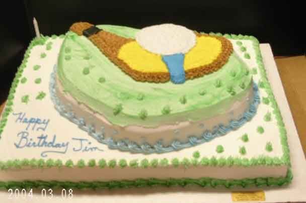 Birthday cake decorated with a golf club and ball, green frosting, blue 