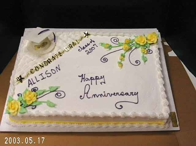 Rectangular white cake with yellow trim, decorated with yellow roses, 