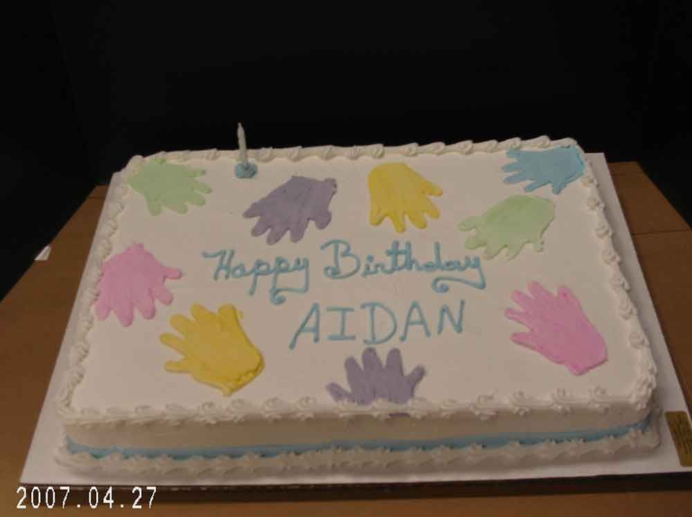Cake with colorful handprints, 