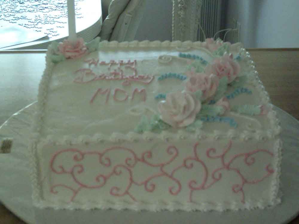 White rectangular cake decorated with pink roses and 