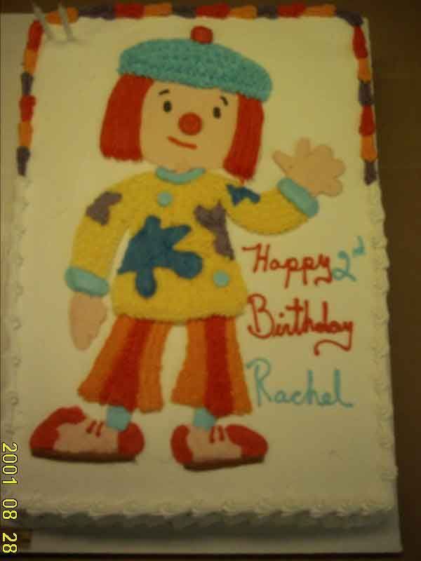 Cake decorated as a clown waving, with 