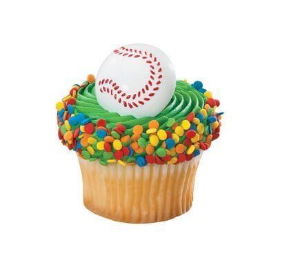 Cupcake with green frosting, sprinkles, and baseball topper.