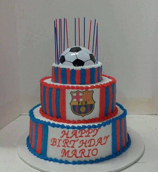 Three-tiered birthday cake decorated with soccer ball and FC Barcelona logo, blue and red stripes, with candles.
