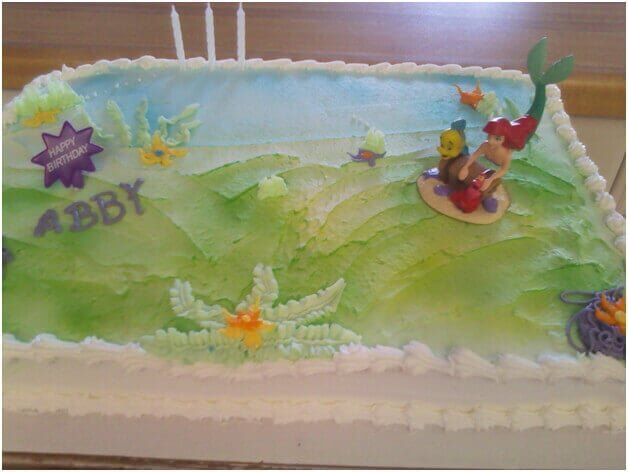 Birthday cake decorated with Ariel the Little Mermaid, waves, and Abby's name.
