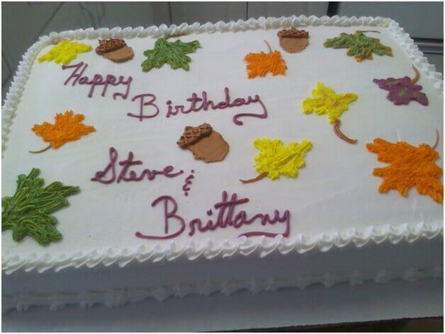 White rectangular cake decorated with fall leaves and acorns; 