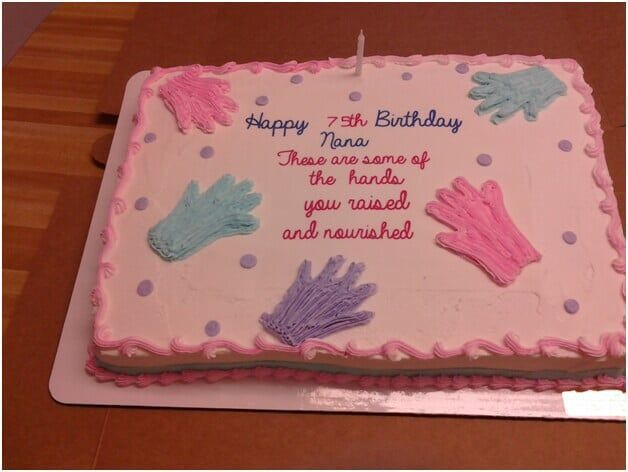 Birthday cake with frosting in the colors pink, purple, and blue. Hands decorate the cake. Text reads 