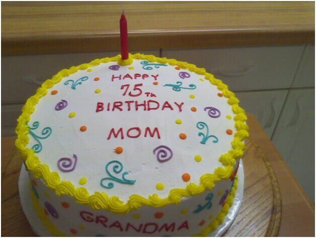 Birthday cake decorated with frosting and a candle; text reads 