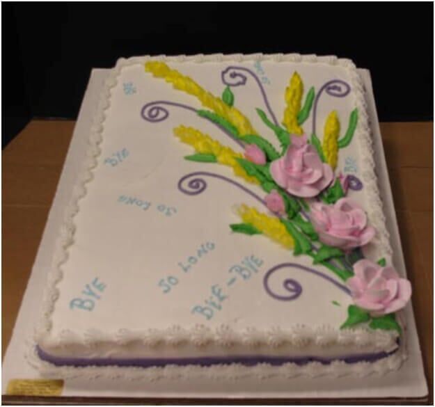 Farewell cake with white frosting, decorated with flowers and 
