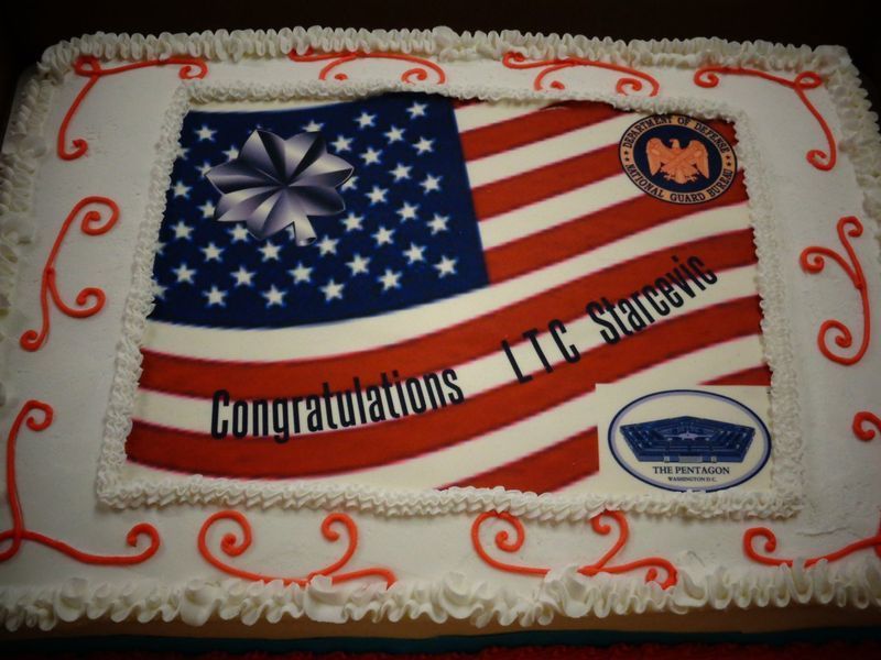 Cake decorated with an American flag, Pentagon logo, and text 