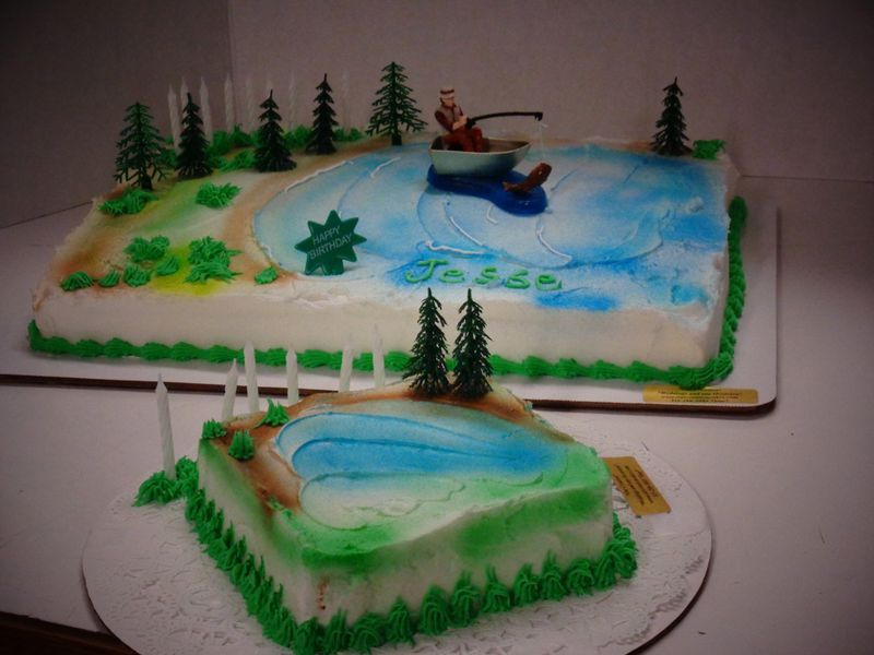 Two cakes decorated as a lake scene: large cake with a fishing figure, small cake with lake detail.