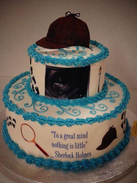 Two-tiered cake decorated with Sherlock Holmes theme, a deerstalker hat, blue frosting, and quote.