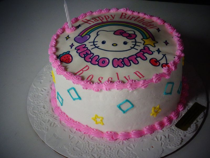 Hello Kitty birthday cake with rainbow, stars, and pink frosting.