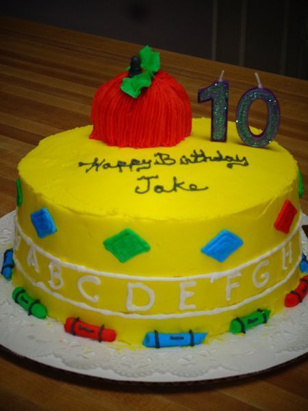 Yellow cake decorated with school theme, apple topper, 