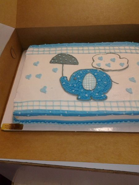 Blue elephant cake with umbrella and hearts for baby shower.