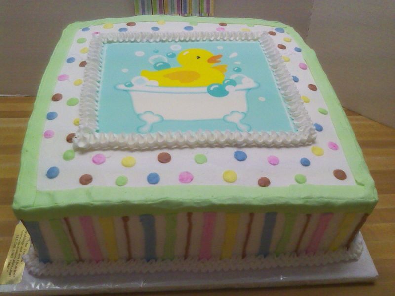 Square baby shower cake with duck in bathtub design, pastel colors.