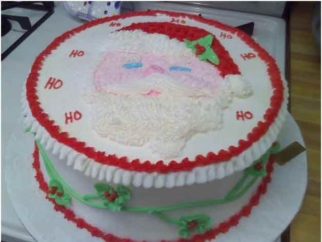Christmas cake decorated with Santa Claus, red and green accents.