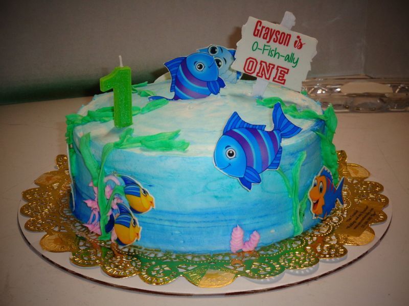 Birthday cake decorated with blue fish and green seaweed, 
