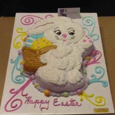 Easter bunny cake with basket, surrounded by colorful swirls and 