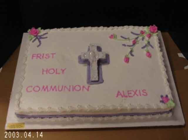 Cake decorated for a First Holy Communion. White frosting with a cross and 