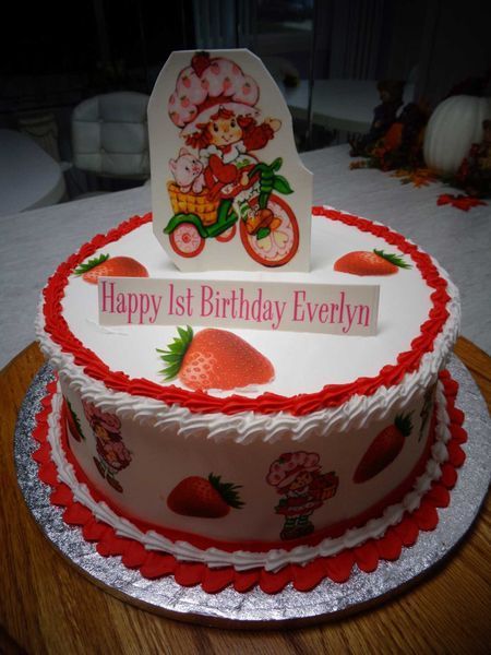 Strawberry Shortcake birthday cake with character image, strawberries, and 