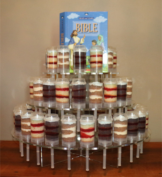 Cake pops arranged in tiers, topped with a Bible.