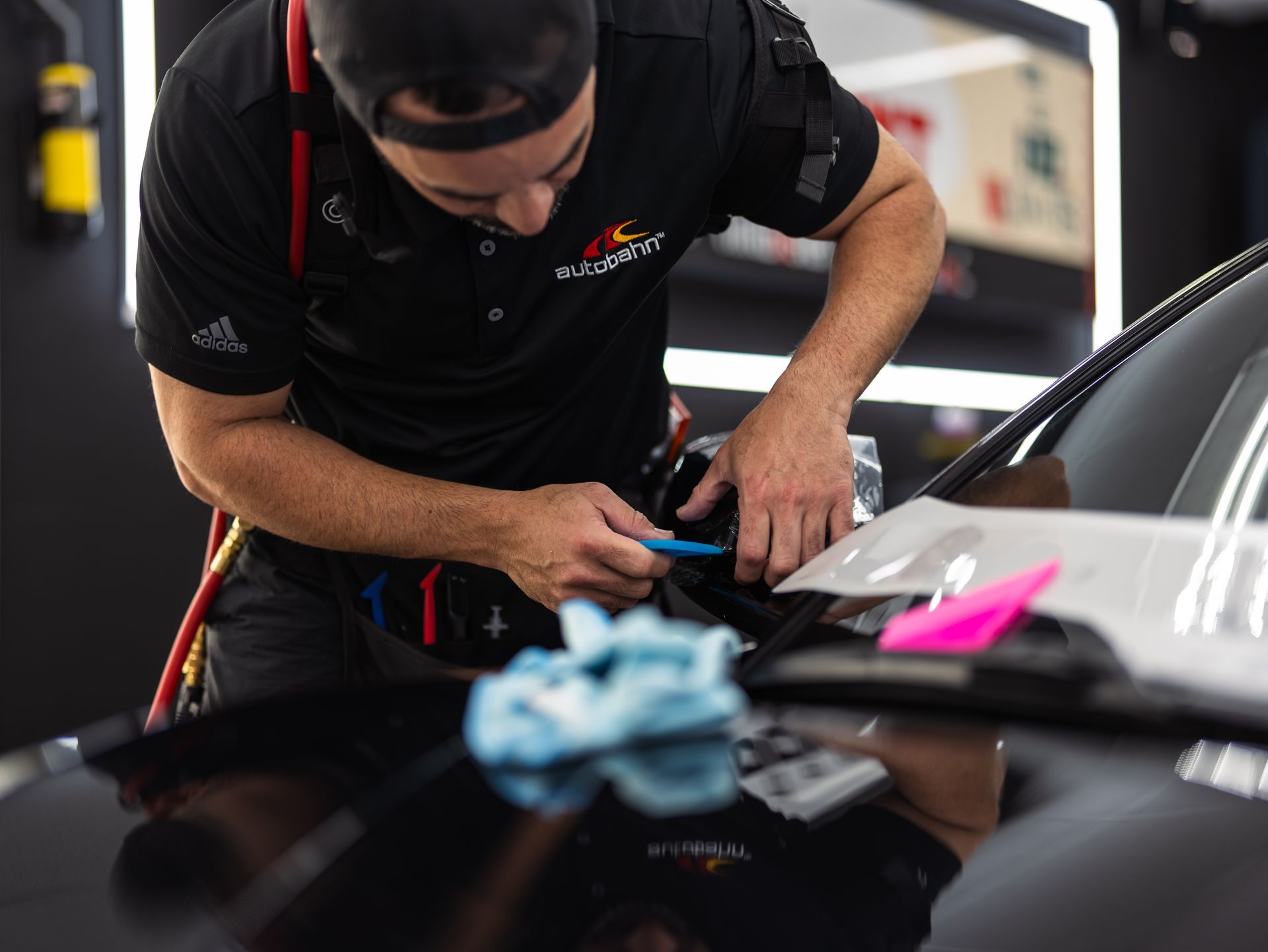 A man is working on a car in a garage.