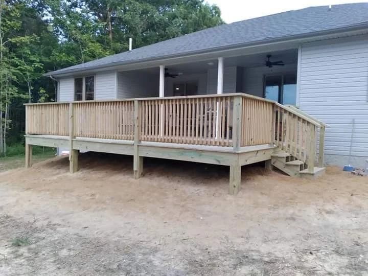 A large wooden deck is in front of a house